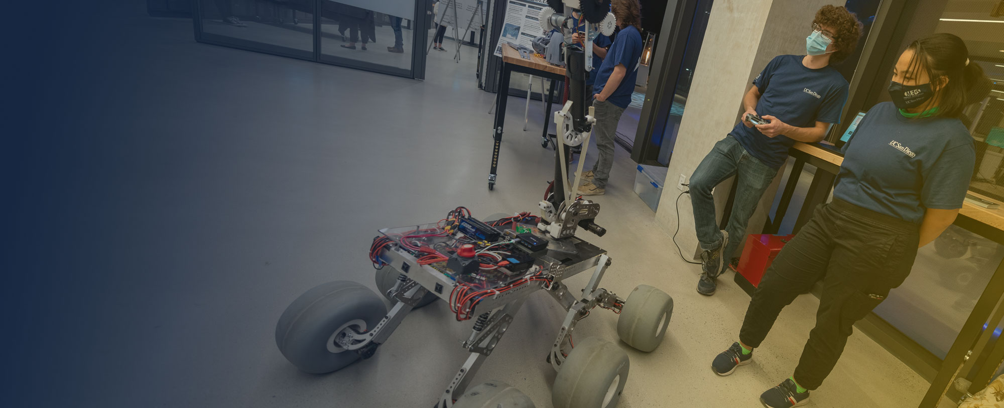 Student innovators controlling a robotic vehicle