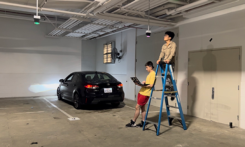 Students work on new parking sensors in parking garage