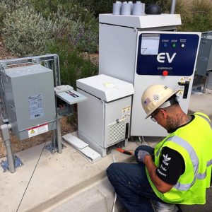 Nuvve employee working on an electric charging station